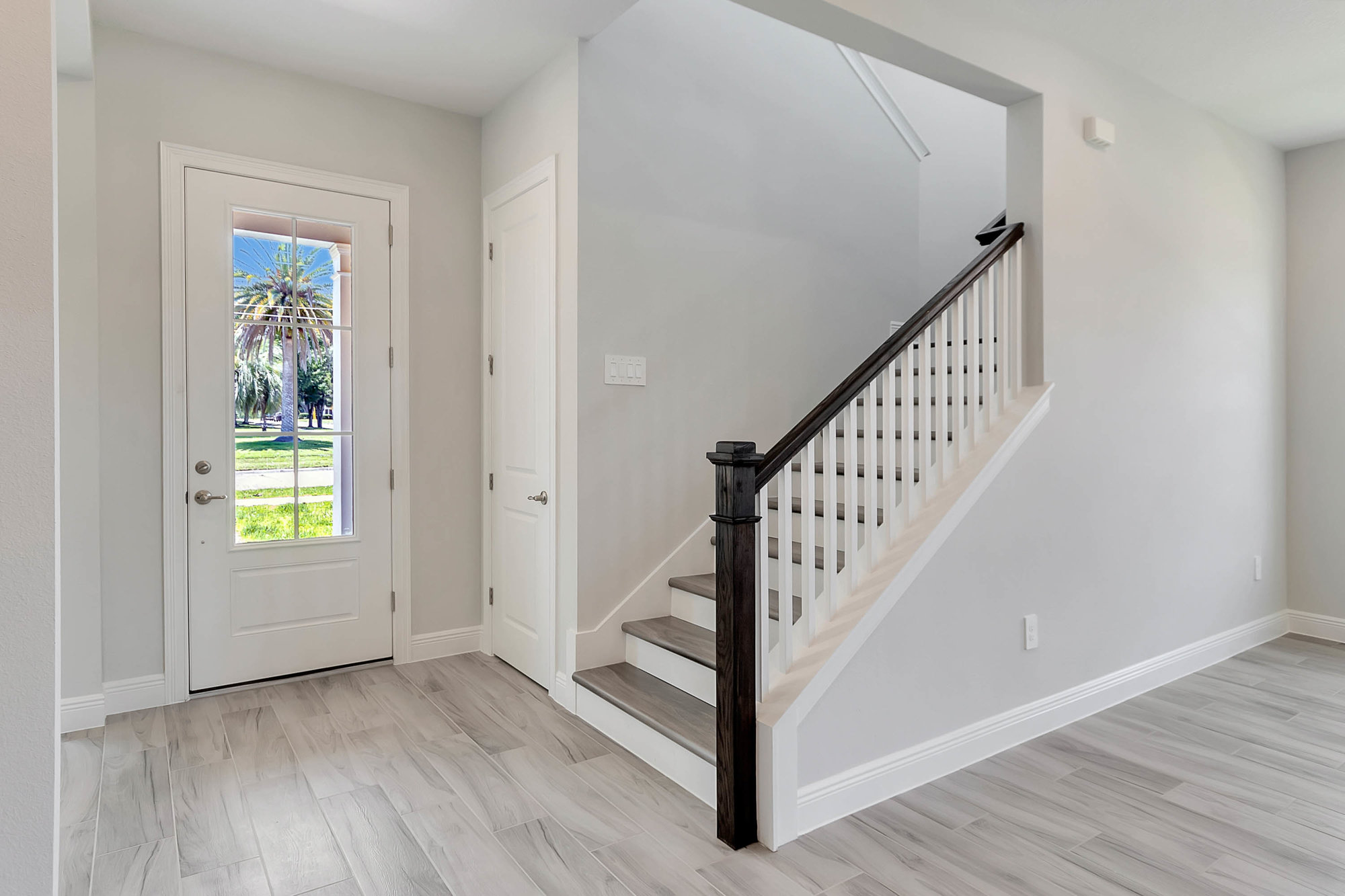 inside front entrance with white walls and stairs